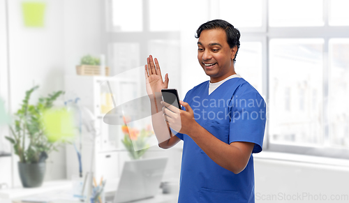 Image of doctor or male nurse having video call on phone