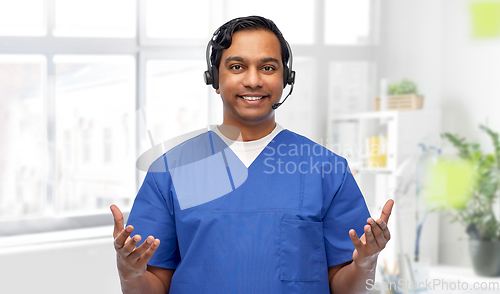 Image of smiling indian doctor or male nurse with headset