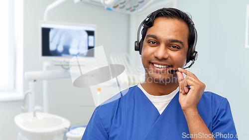Image of smiling indian doctor or male nurse with headset