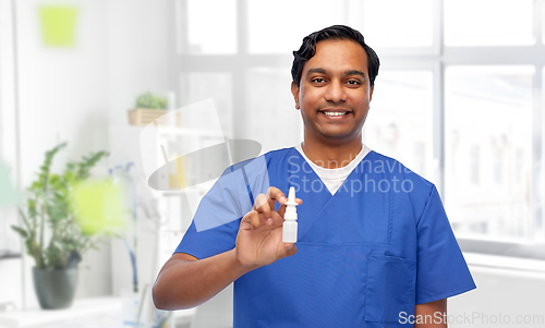 Image of smiling indian male doctor or nurse with medicine