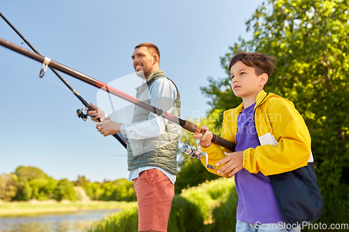 Image of father and son fishing on river