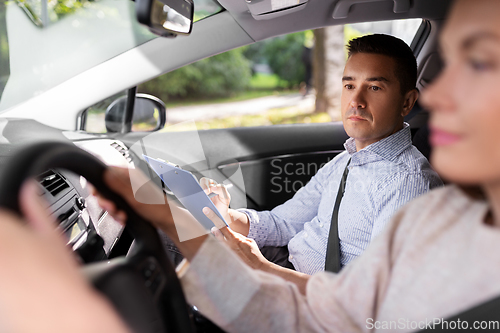 Image of car driving school instructor and young driver