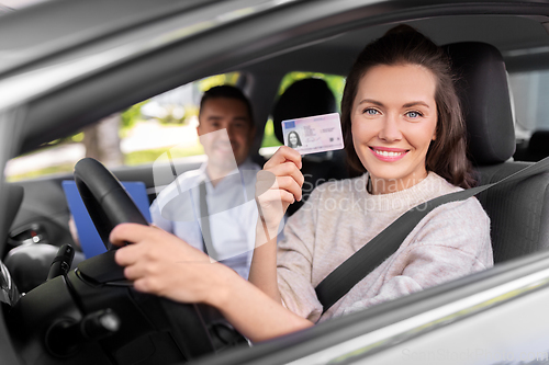 Image of car driving instructor and driver with license