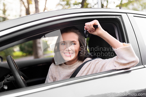 Image of woman or female driver with car key in city