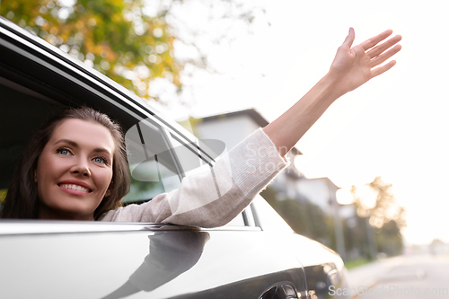 Image of happy smiling woman or female passenger in car