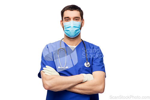 Image of male doctor in blue uniform, mask and gloves