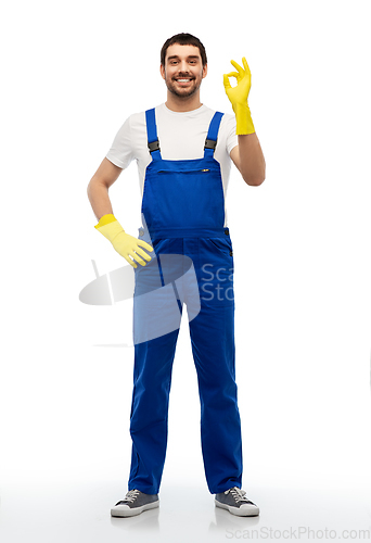 Image of happy male worker or cleaner showing ok hand sign