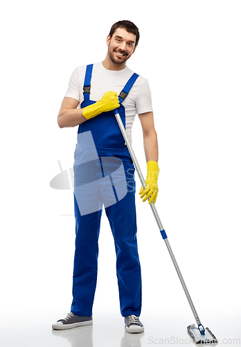 Image of male cleaner in overal cleaning floor with mop