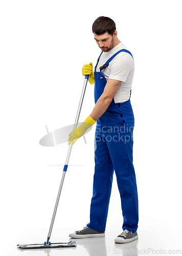 Image of male cleaner in overal cleaning floor with mop