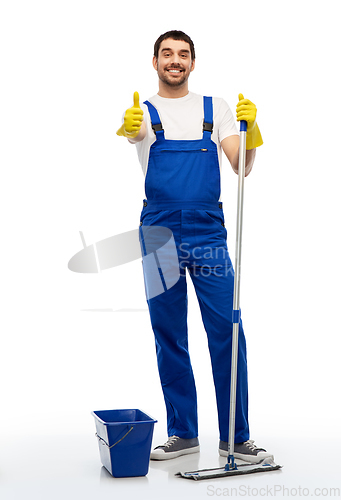 Image of man cleaning with mop and bucket showing thumbs up