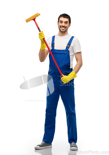 Image of male cleaner in overal with window cleaning mop