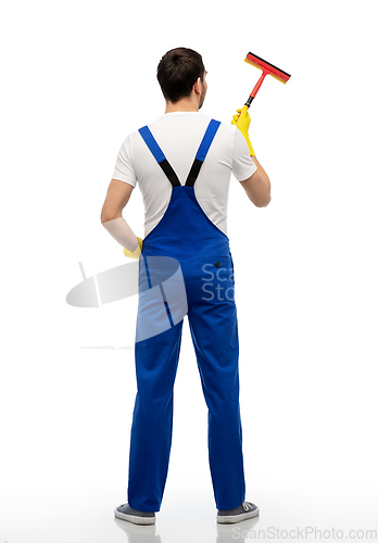 Image of male cleaner in overal with window cleaning mop