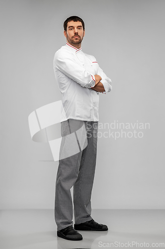 Image of male chef in jacket with crossed arms