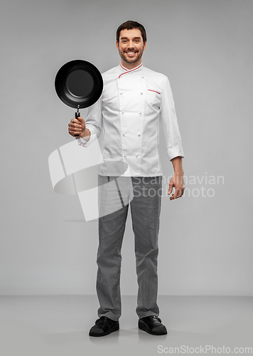 Image of happy smiling male chef in jacket with frying pan