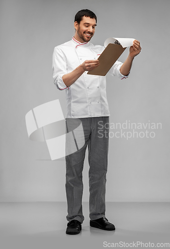 Image of happy smiling male chef with clipboard