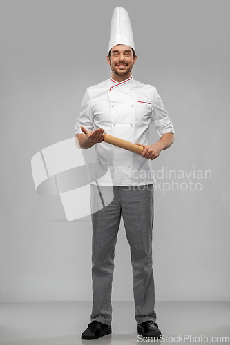 Image of happy smiling male chef or baker with rolling pin