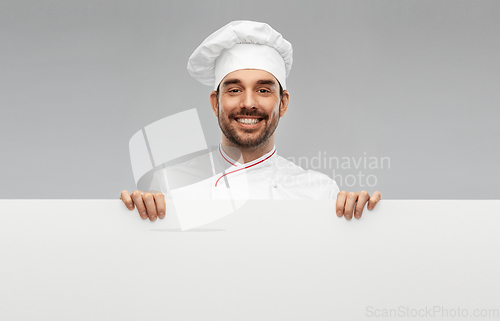 Image of happy smiling male chef with big white board