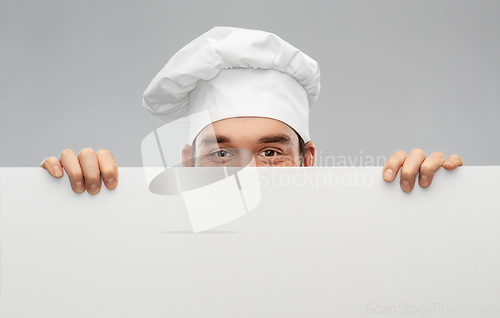 Image of happy smiling male chef with big white board