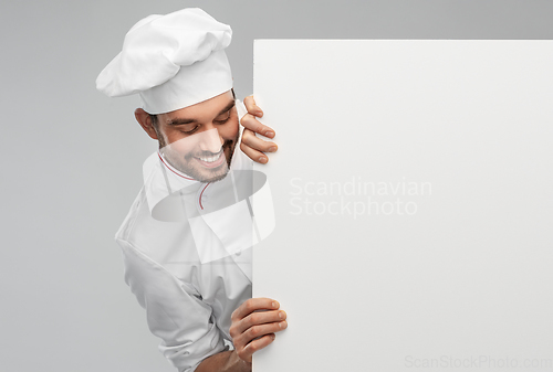 Image of happy smiling male chef with big white board