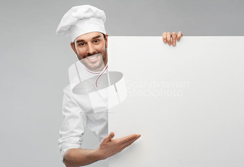 Image of happy smiling male chef with big white board