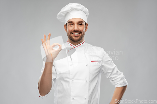 Image of happy smiling male chef showing ok hand sign