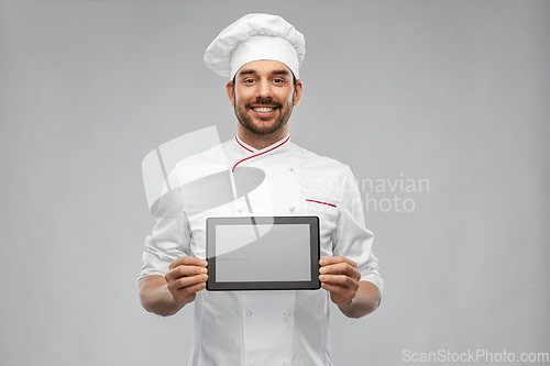 Image of happy smiling male chef showing tablet pc computer