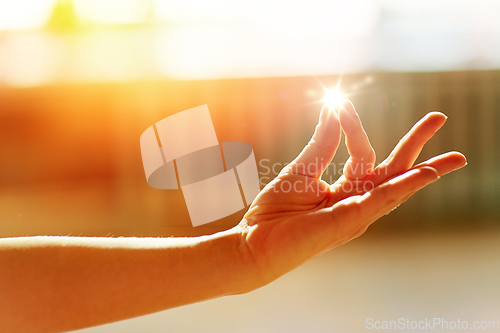 Image of hand of meditating yogi woman showing gyan mudra