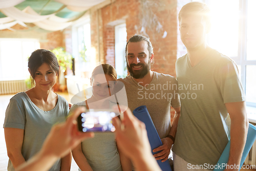 Image of happy people at yoga studio or gym photographing