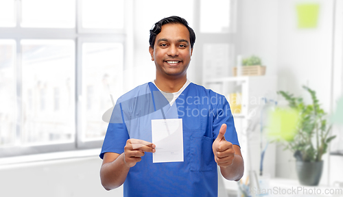 Image of indian doctor with prescription showing thumbs up