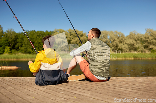 Image of father and son fishing on river