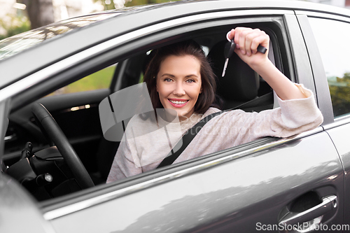 Image of woman or female driver with car key in city