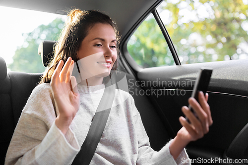 Image of woman in taxi car having video call on smartphone