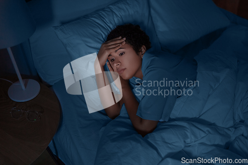 Image of sleepless african woman lying in bed at night