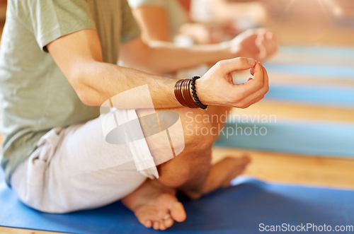 Image of group of people making yoga exercises at studio