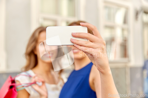 Image of happy women taking selfie with smartphone