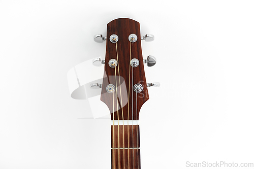 Image of close up of acoustic guitar head with pegs