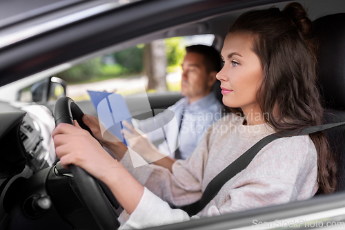 Image of car driving school instructor and young driver