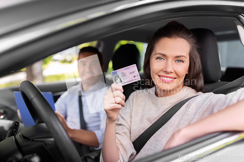 Image of car driving instructor and driver with license