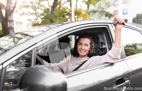 Image of woman or female driver with car key in city