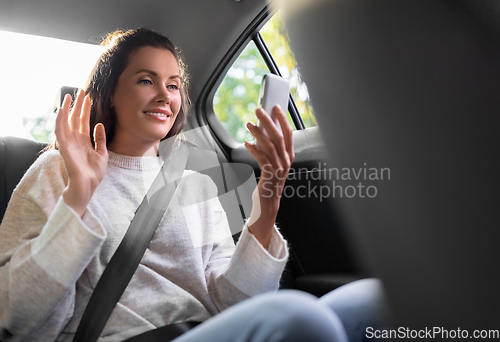 Image of woman in taxi car having video call on smartphone