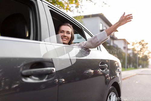 Image of happy smiling woman or female passenger in car
