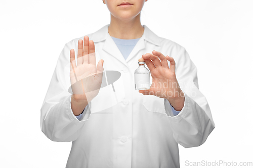 Image of close up of doctor with syringe shows stop gesture