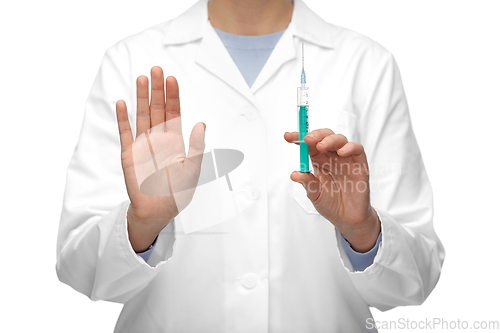 Image of close up of doctor with syringe shows stop gesture