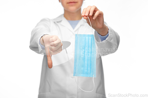 Image of female doctor with mask showing thumbs down