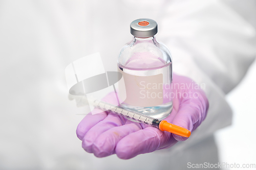 Image of close up of doctor with medicine and syringe