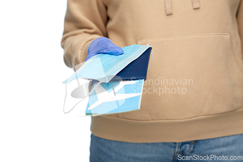 Image of woman with mask, passport and air ticket