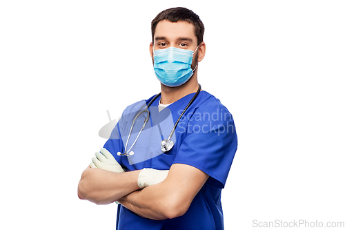 Image of male doctor in blue uniform, mask and gloves