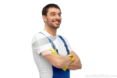 Image of happy male worker or cleaner in overall and gloves