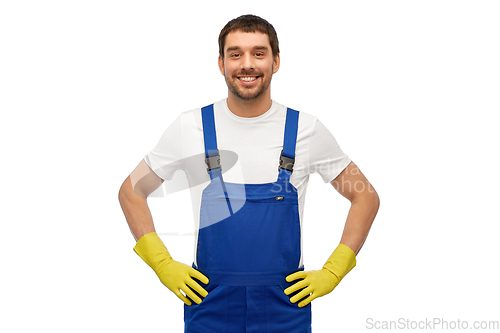 Image of happy male worker or cleaner in overall and gloves