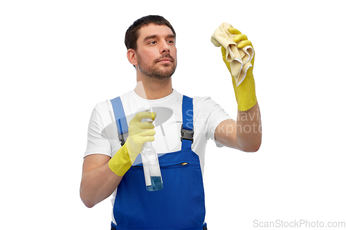 Image of male cleaner cleaning with rag and detergent